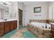 Bright bathroom featuring a soaking tub with tile surround, double vanity, and glass door shower at 416 Zelkova St, York, SC 29745