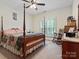 Charming bedroom with a four-poster bed, rocking chair, and plenty of natural light at 416 Zelkova St, York, SC 29745