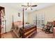 Bedroom with wood post bed, rocking chair, and plantation shutters at 416 Zelkova St, York, SC 29745