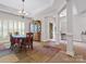 Dining room featuring hardwood floors, chandelier, and decorative columns, open to foyer at 416 Zelkova St, York, SC 29745