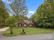 Charming brick home featuring a manicured lawn and mature trees at 416 Zelkova St, York, SC 29745