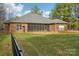 Brick house with large screened porch and grassy backyard at 416 Zelkova St, York, SC 29745