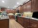 Spacious kitchen features granite countertops, wooden cabinetry, stainless steel appliances and tile backsplash at 416 Zelkova St, York, SC 29745