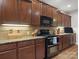 Modern kitchen featuring granite countertops, sleek wooden cabinets, and stainless steel appliances at 416 Zelkova St, York, SC 29745