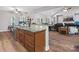 Open concept kitchen island featuring granite countertops and stainless steel dishwasher overlooking living room at 416 Zelkova St, York, SC 29745