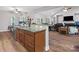 Open concept kitchen island featuring granite countertops and stainless steel dishwasher overlooking living room at 416 Zelkova St, York, SC 29745