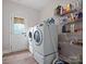 Functional laundry room with modern washer and dryer and ample shelving space at 416 Zelkova St, York, SC 29745