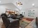 Living room with vaulted ceiling featuring hardwood floors, leather furniture, and a large window at 416 Zelkova St, York, SC 29745