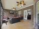 Inviting screened-in porch with brick surround featuring wicker seating and ceiling fan at 416 Zelkova St, York, SC 29745