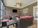 Inviting screened-in porch with brick surround featuring wicker seating and ceiling fan at 416 Zelkova St, York, SC 29745