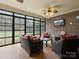Inviting screened-in porch with brick surround featuring wicker seating and ceiling fan, and enclosed screens at 416 Zelkova St, York, SC 29745