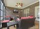 Inviting screened-in porch with brick surround featuring wicker seating and ceiling fan at 416 Zelkova St, York, SC 29745