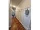 Hardwood floor hallway with wainscoting and coat hooks at 4392 Enchantment Cove Ln, Charlotte, NC 28216