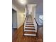 Hardwood staircase with white railing and banister at 4392 Enchantment Cove Ln, Charlotte, NC 28216