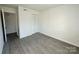 Spacious bedroom with double door closet and wood-look floors at 4822 Spring Lake Dr, Charlotte, NC 28212