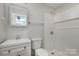 Clean bathroom with shower and white vanity at 504 E Poplar St, Dallas, NC 28034