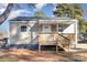 Newly constructed light beige home with a wooden deck and steps at 504 E Poplar St, Dallas, NC 28034