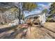 Tan colored house with wooden deck and steps, next to another home at 504 E Poplar St, Dallas, NC 28034
