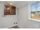 Laundry area with wooden cabinets and backyard view at 504 E Poplar St, Dallas, NC 28034