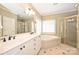 Elegant bathroom with double vanity, corner bathtub, and a glass shower at 6726 Thornton Oaks Ct, Charlotte, NC 28270