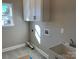 Laundry room with white cabinets and gray tile floor at 7311 Mooresville Rd, Salisbury, NC 28147