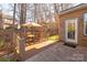 Deck with table and chairs, overlooks a wooded backyard at 7922 Sardis Creek Ln, Charlotte, NC 28270