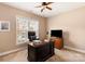 Home office with built-in desk and large window at 7922 Sardis Creek Ln, Charlotte, NC 28270