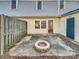 Private backyard patio with a fire pit and wood fence at 8003 Regent Park Ln, Charlotte, NC 28210