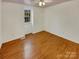 Well-lit bedroom, featuring wood-look floors and a window at 8003 Regent Park Ln, Charlotte, NC 28210