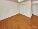 Bright bedroom with wood-look floors and double doors to closet at 8003 Regent Park Ln, Charlotte, NC 28210