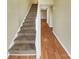 Entryway with hardwood floors, carpeted stairs, and neutral walls at 8003 Regent Park Ln, Charlotte, NC 28210