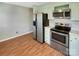 Kitchen with light green cabinets and stainless steel appliances at 8003 Regent Park Ln, Charlotte, NC 28210