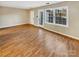 Spacious living room featuring light hardwood floors and neutral walls at 8003 Regent Park Ln, Charlotte, NC 28210