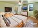 Virtually staged main bedroom with light walls, hardwood floors and en-suite bathroom at 8003 Regent Park Ln, Charlotte, NC 28210