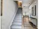 Modern staircase with gray carpeting and wooden handrail at 8008 Downy Oak Ln, Charlotte, NC 28269