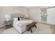 Main bedroom with plush bed, nightstands, and barn door to en-suite bath at 8260 Blades Trl, Denver, NC 28037