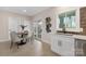 Eat-in kitchen with white cabinets, quartz countertops and access to backyard at 8260 Blades Trl, Denver, NC 28037