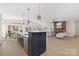 Open kitchen with island and stainless steel appliances at 8260 Blades Trl, Denver, NC 28037