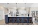 Modern kitchen with white cabinets, quartz countertops, and a large island at 8260 Blades Trl, Denver, NC 28037