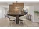 Rustic-modern kitchen island with bar stools and white cabinetry at 8260 Blades Trl, Denver, NC 28037