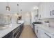 Modern kitchen with white cabinets and a large island at 8260 Blades Trl, Denver, NC 28037