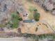 An aerial view showcasing a home with a pool, nestled on a spacious lot with mature trees at 9330 Bellhaven Blvd, Charlotte, NC 28214