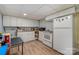 Well-equipped basement kitchenette with white cabinets and appliances at 9330 Bellhaven Blvd, Charlotte, NC 28214