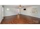 Large bedroom with hardwood floors, a ceiling fan, and access to a full bathroom at 9330 Bellhaven Blvd, Charlotte, NC 28214