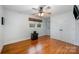 Spacious bedroom with hardwood floors, ceiling fan, and double doors to closet at 9330 Bellhaven Blvd, Charlotte, NC 28214