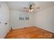 Well-lit bedroom with hardwood floors and a ceiling fan at 9330 Bellhaven Blvd, Charlotte, NC 28214
