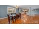 Bright dining room features hardwood floors and a view into the updated kitchen at 9330 Bellhaven Blvd, Charlotte, NC 28214