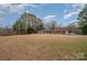 Ranch home on a large lot with trees and a driveway at 9330 Bellhaven Blvd, Charlotte, NC 28214