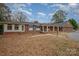 Ranch style home with brick exterior and mature trees at 9330 Bellhaven Blvd, Charlotte, NC 28214