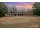 Brick ranch home with a large yard and circular driveway at 9330 Bellhaven Blvd, Charlotte, NC 28214